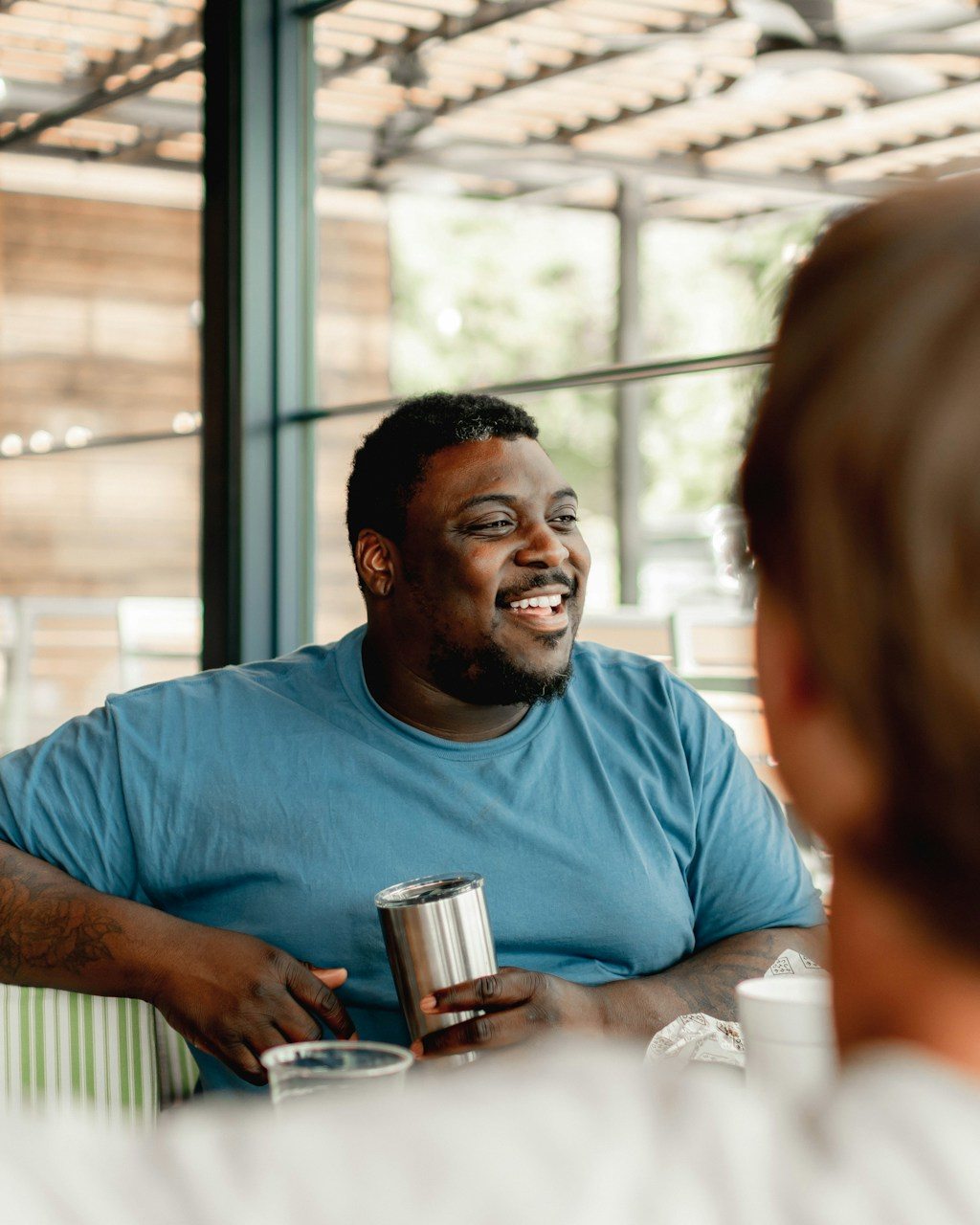 A smiling person speaking with a counselor