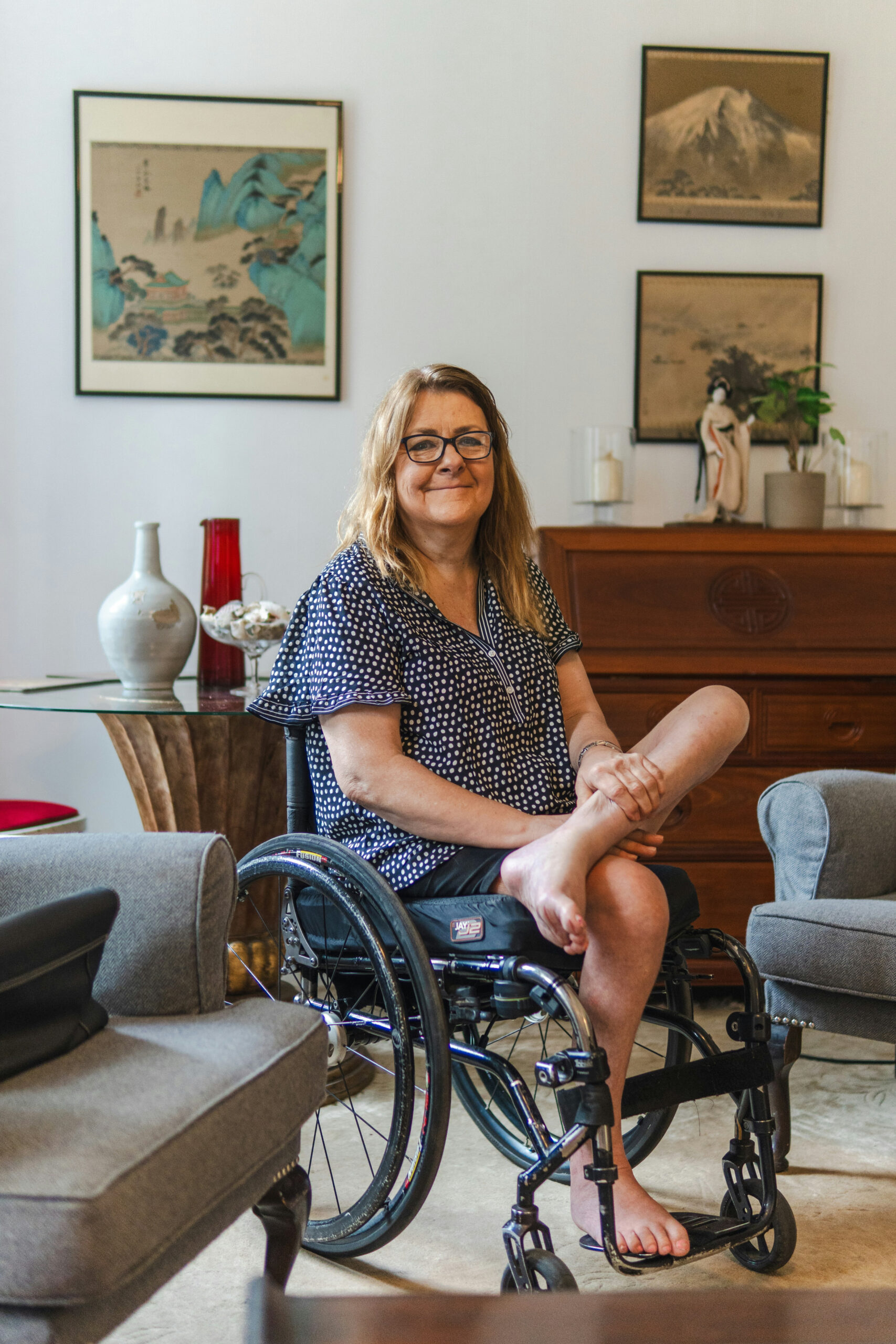 Woman seated in a wheelchair in a living room